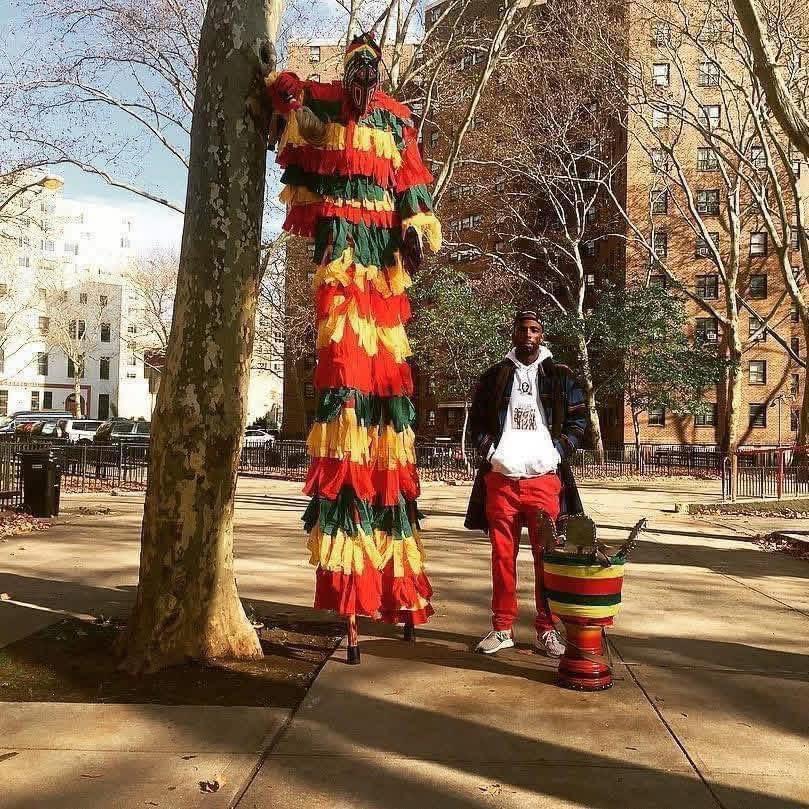 King Joox with traditional Nigerian masquerade figure